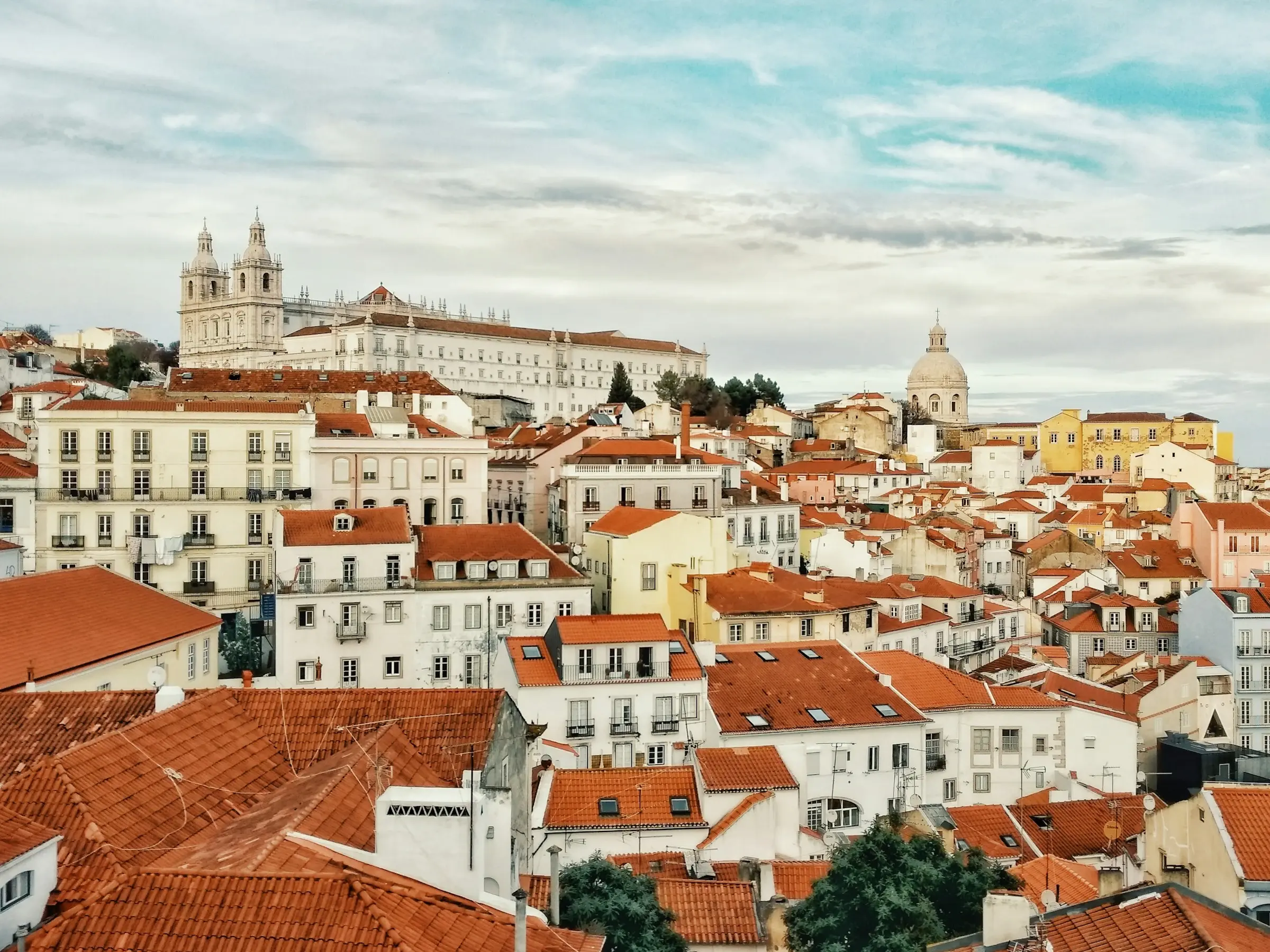 Late winter sunshine on the yellow facades and tiled rooftops of Lisbon's Baixa in February