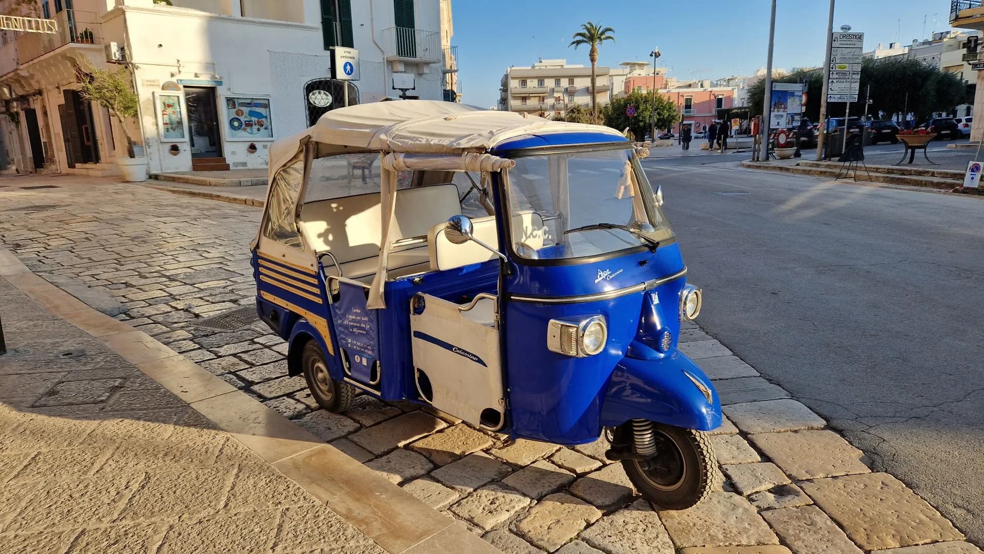 Electric tuk tuk parked on a narrow cobbled street in the Alfama district of Lisbon